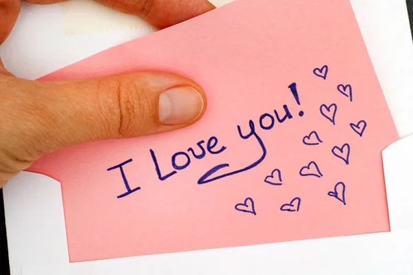 Woman hand taking out letter with text I Love You! from envelope — Stock Photo, Image