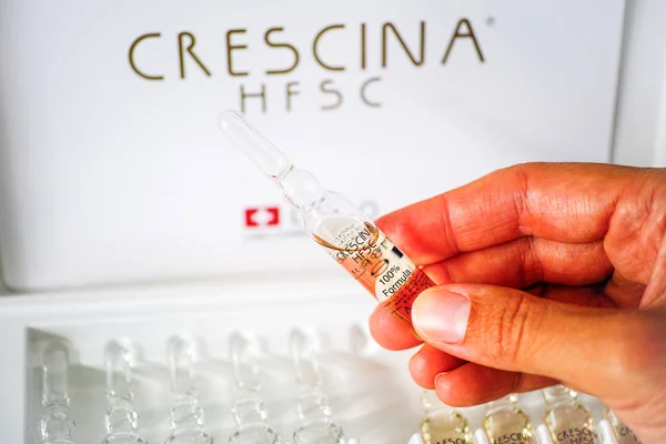 Kvinna hand med ampull av Crescina Hfsc återväxt formel — Stockfoto
