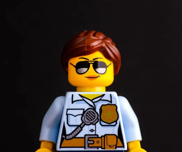 Portrait of Lego policewoman minifigure on black background — Stock Photo, Image