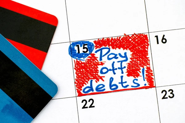 Reminder Pay off Debts in calendar with credit cards. — Stock Photo, Image