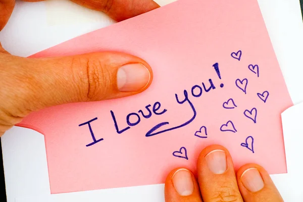 Woman hands taking out letter with text I Love You! from envelope — Stock Photo, Image