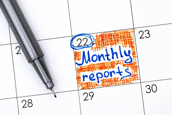 Reminder Monthly Reports in calendar with pen.
