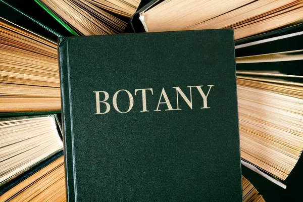 Old hardback books with book Botany on top. — Stock Photo, Image