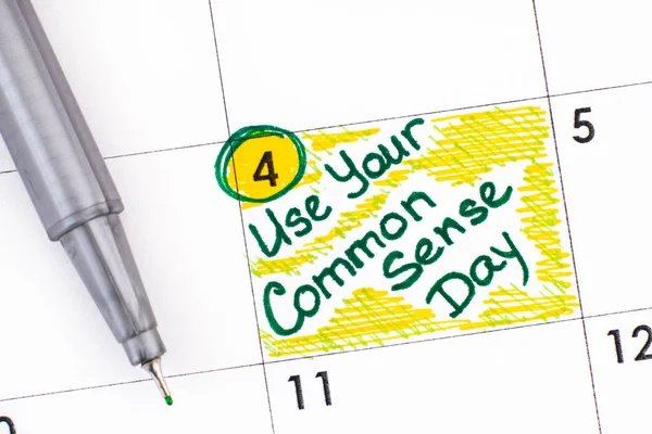 Reminder Use Your Common Sense Day in calendar with green pen.