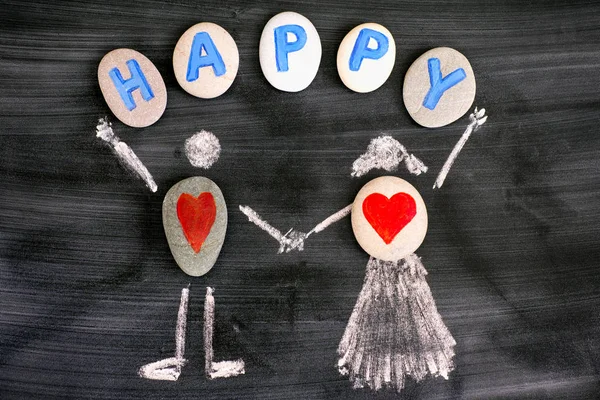 Pebbles with red hearts inside chalk drawing of man and woman an — Stock Photo, Image