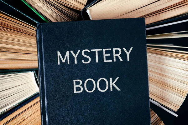 Old hardback books with Mystery Book on top. — Stock Photo, Image