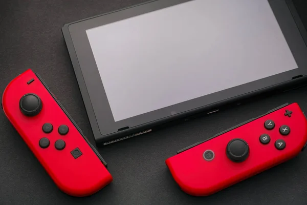 Nintendo Switch video game console and two Joy-Cons on black bac — Stock Photo, Image