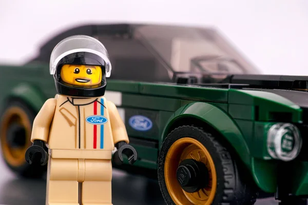 Lego 1968 Ford Mustang Fastback driver minifigure against his ca — Stock Photo, Image
