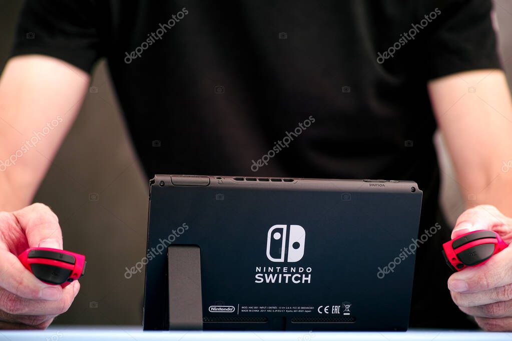 Tambov, Russian Federation - September 07, 2019 Man playing Nintendo Switch video game console indoors.