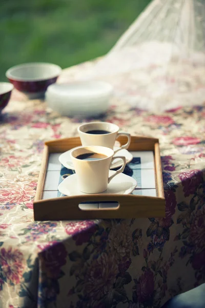 Two cups of coffee in nature in romantic environment, crossproce — Stock Photo, Image