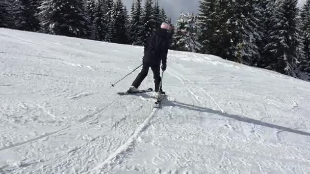 Young female learning to ski using plough technique — Stock Video