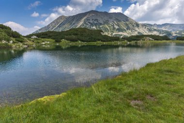 Panorama with Todorka Peak and reflection in Muratovo lake, Pirin Mountain clipart