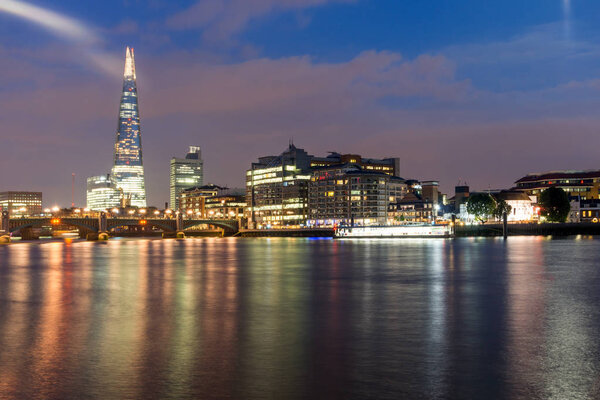 LONDON, ENGLAND - JUNE 17 2016: Night Panorama of Southwark Bridge, The Shard  skyscraper and Thames River, London
