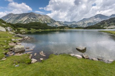 Panorama of Banderishki Chukar and Todorka Peaks and reflection in Muratovo lake, clipart