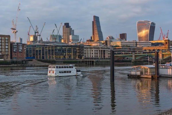 LONDON, ENGLAND - JUNE 18, 2016: Amazing sunset Cityscape from Millennium Bridge and Thames River, London