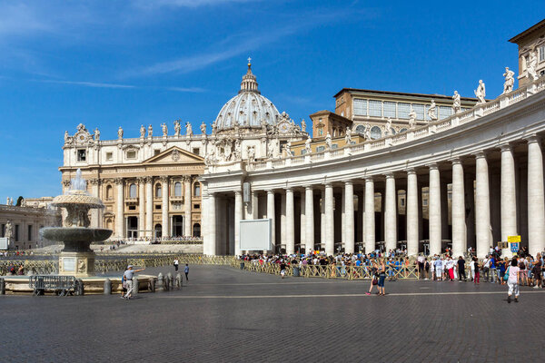 ROME, ITALY - JUNE 23, 2017: Tourists visit Saint Peter's Square and St. Peter's Basilica in Rome, Vatican