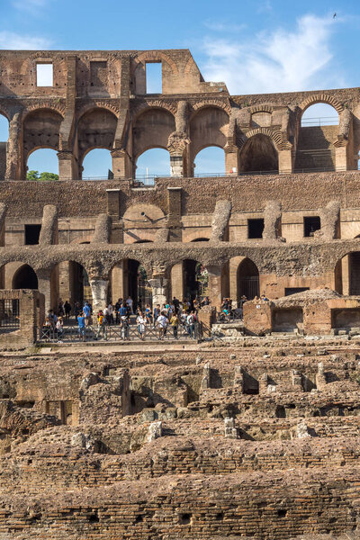 ROME, ITALY - JUNE 24, 2017: Tourists visiting inside part of  Colosseum in city of Rome, Italy