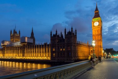 LONDON, ENGLAND - JUNE 16 2016: Night photo of Houses of Parliament with Big Ben from Westminster bridge, London, England, Great Britain clipart