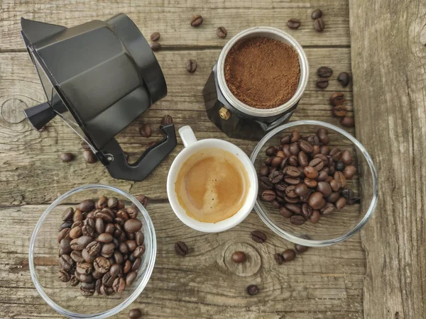 Cup and grain of coffee over wooden background