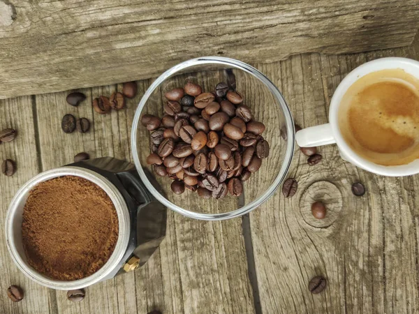 Cup and grain of coffee over wooden background