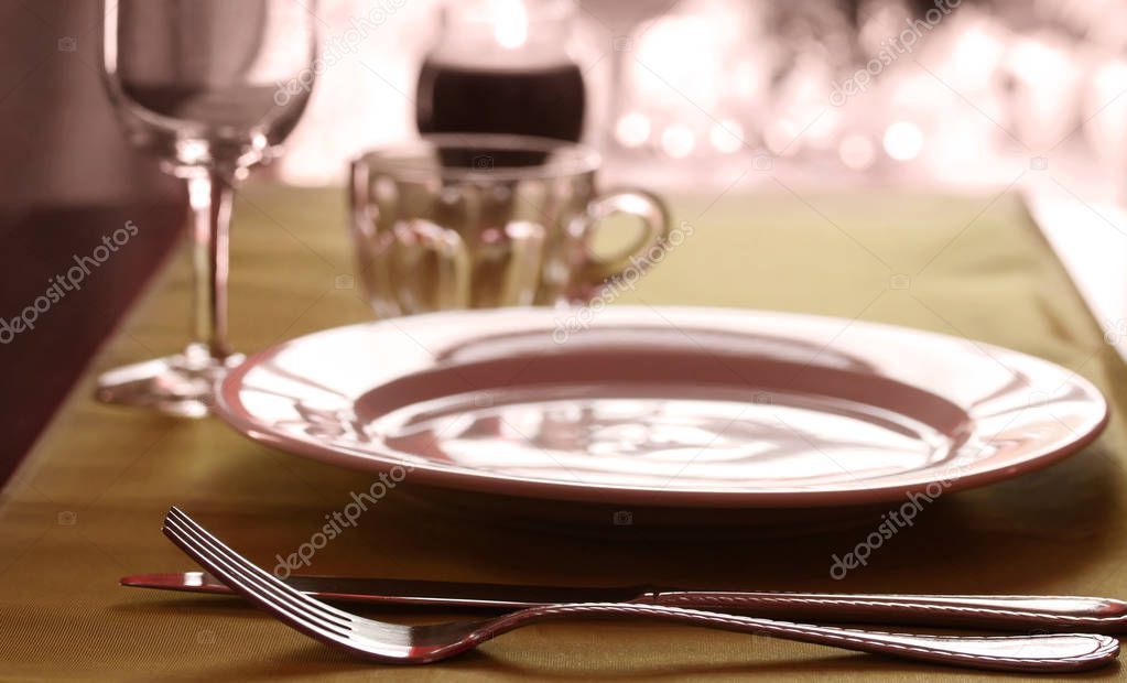 A fancy wedding table place setting in warm tones