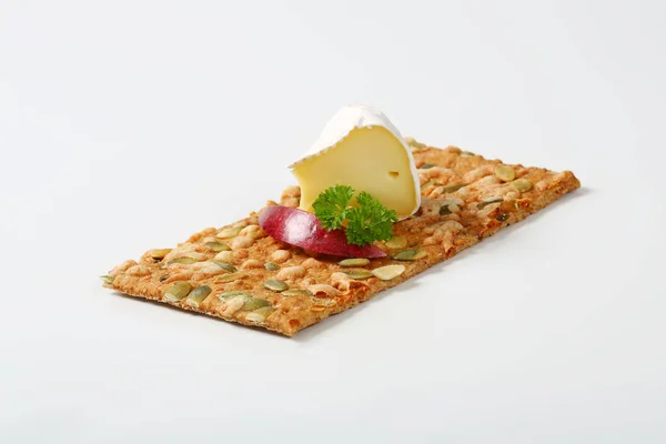 Pumpkin seed cracker with cheese — Stock Photo, Image