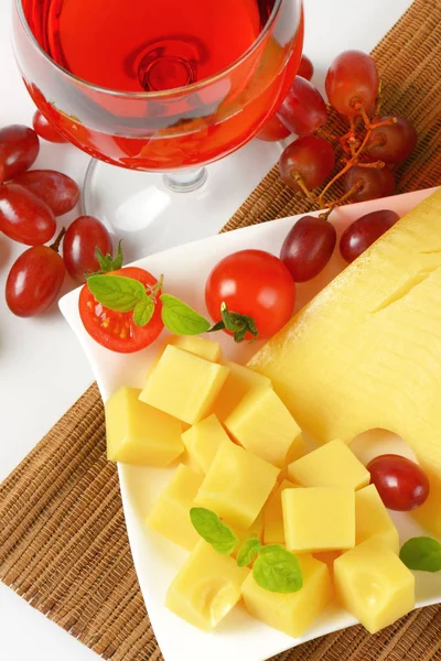 Swiss cheese, red wine and fresh grapes — Stock Photo, Image