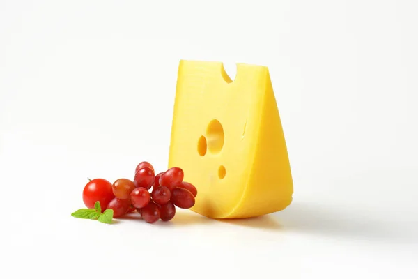 Swiss cheese with red grapes — Stock Photo, Image