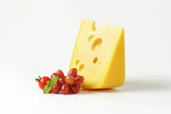 Swiss cheese with red grapes — Stock Photo, Image