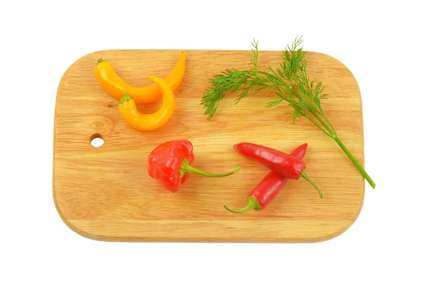 Chili peppers on cutting board — Stock Photo, Image