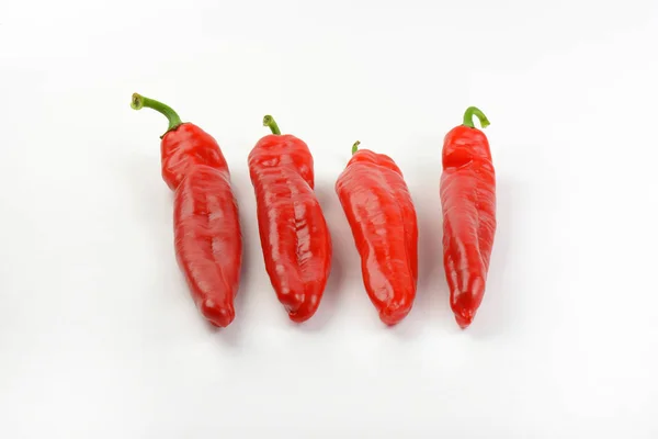 Cuatro pimientos rojos — Foto de Stock