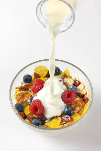 Milk pouring into breakfast cereals — Stock Photo, Image