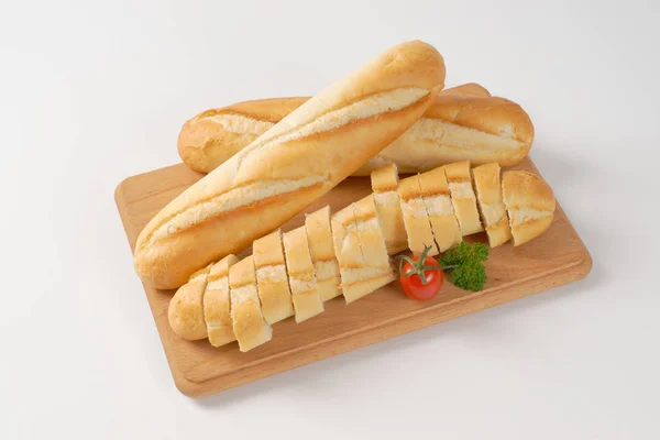 Whole and sliced baguettes — Stock Photo, Image