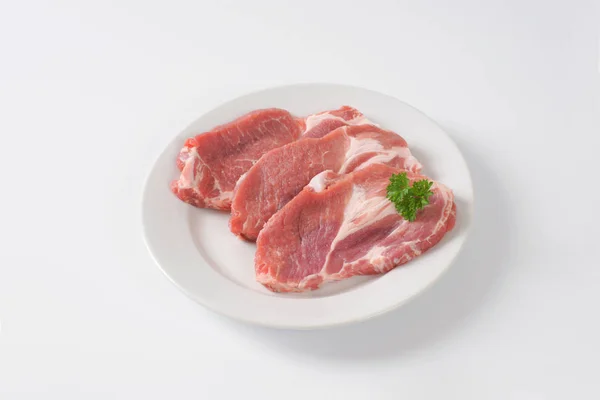 Raw pork neck steaks — Stock Photo, Image