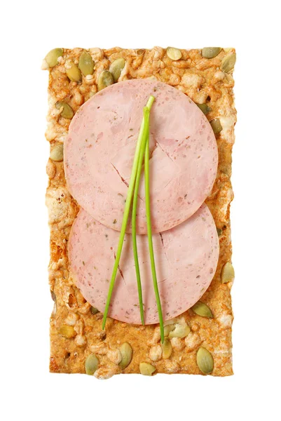 Pumpkin seed cracker with soft sausage slices — Stock Photo, Image