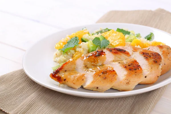 Roasted chicken breast with rice and oranges — Stock Photo, Image