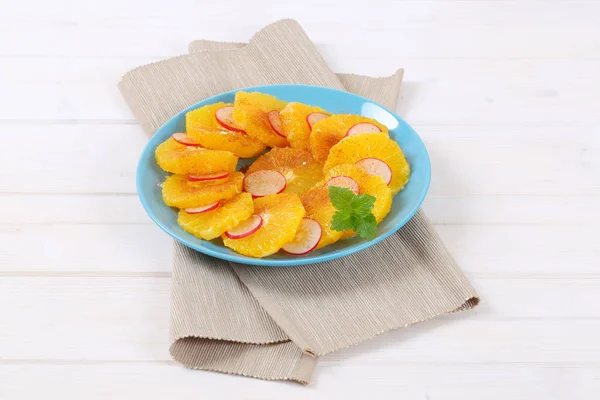 Slices of orange, radish and cinnamon — Stock Photo, Image