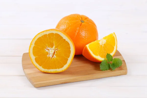 Ganze und in Scheiben geschnittene Orangen — Stockfoto