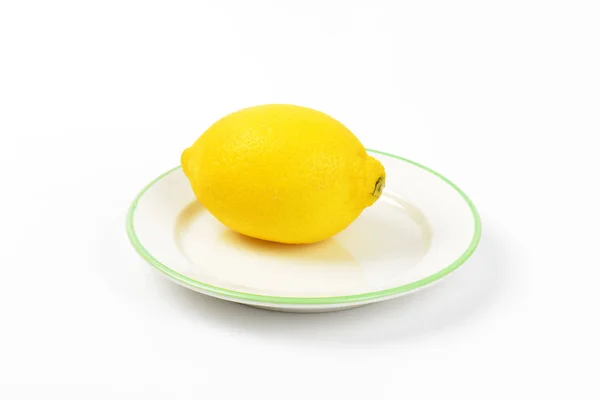 Ripe lemon on plate — Stock Photo, Image