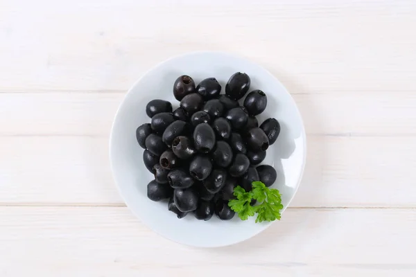 Zwarte olijven met peterselie — Stockfoto