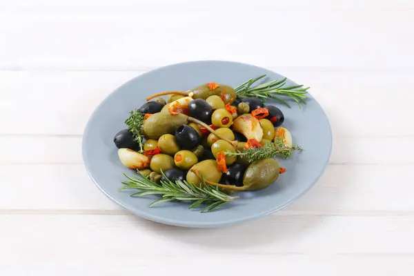 Pickled olives, capers, caper berries and garlic — Stock Photo, Image