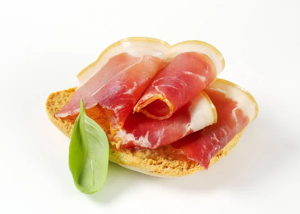 Crispy bread with prosciutto — Stock Photo, Image