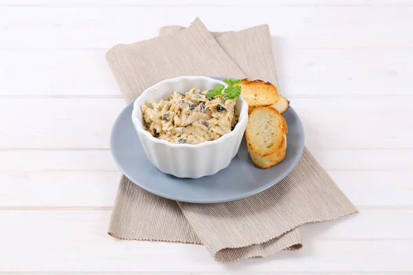 Grated cheese and olive spread with crostini — Stock Photo, Image