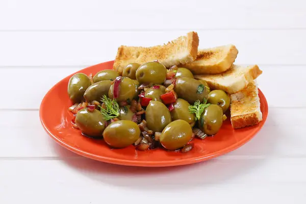 Marinated green olives with toast — Stock Photo, Image