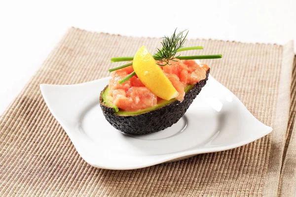 Avocado half stuffed with cured salmon — Stock Photo, Image