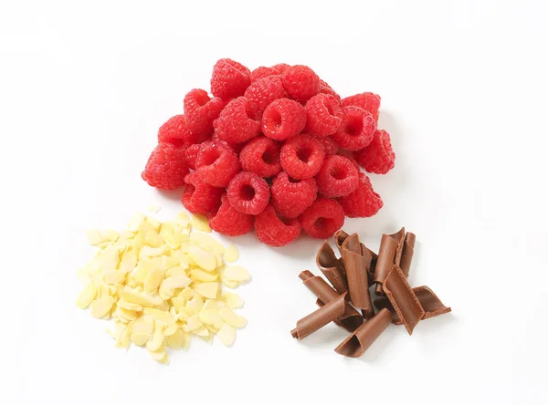 Fresh raspberries, chocolate curls and sliced almonds — Stock Photo, Image