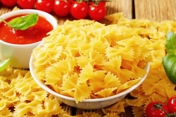 Bow tie pasta and tomato passata — Stock Photo, Image