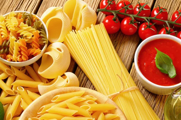 Assorted pasta and tomato passata — Stock Photo, Image