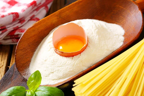 Flour and fresh egg in a scoop — Stock Photo, Image