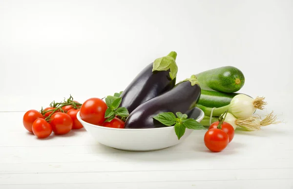 Fresh eggplants, tomatoes, zucchini and spring onion — Stock Photo, Image